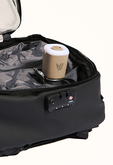 Black suitcase with a beige and white device inside on a white background